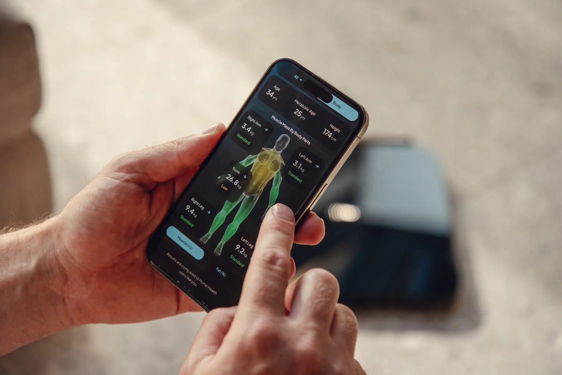 Hume app showing body composition insights with Hume Pod nearby